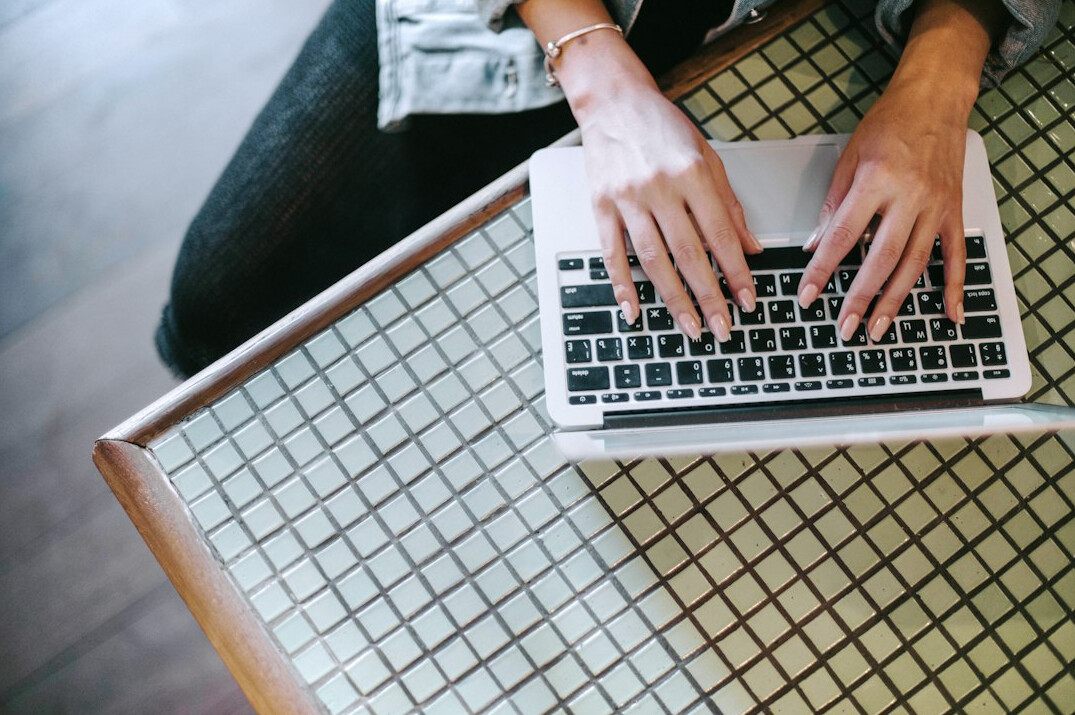 writer typing on laptop