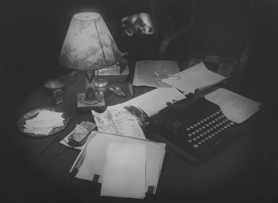 mystery writer at desk with lamp
